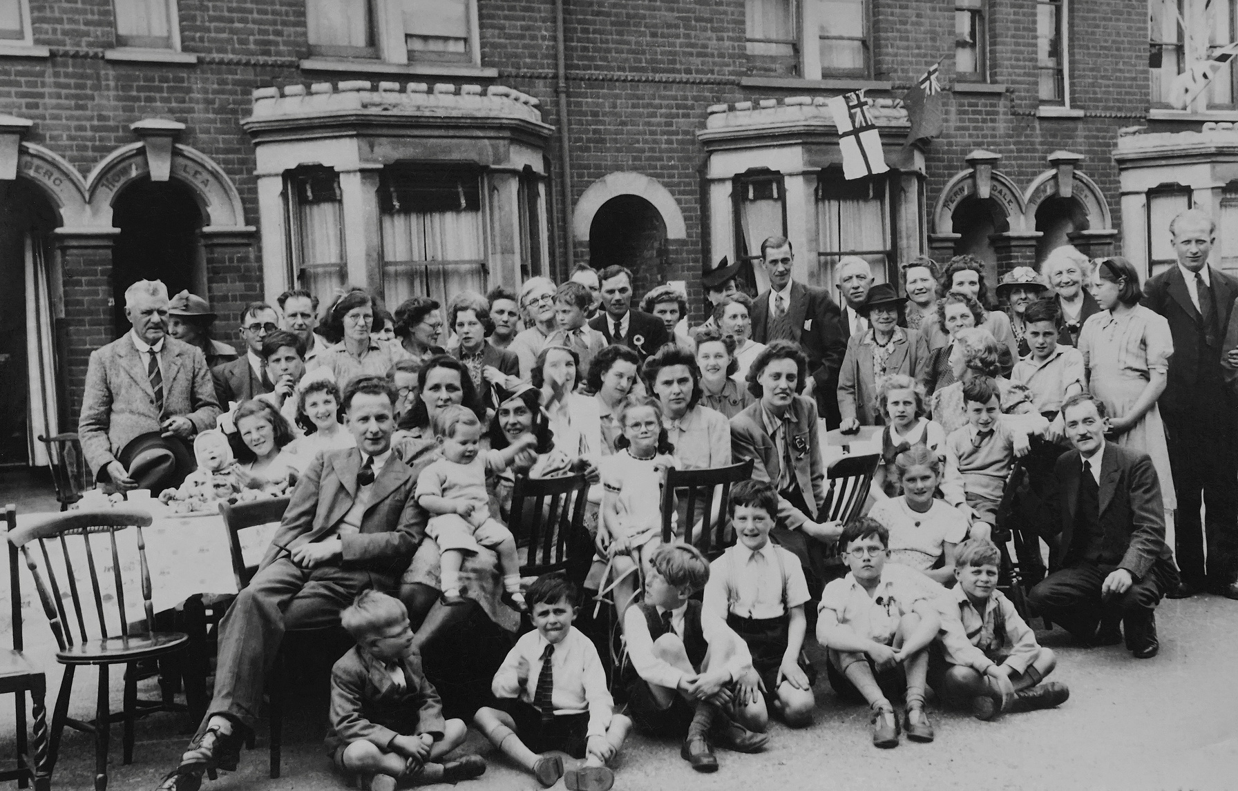 Grayscale Photo of People Sitting on Bench